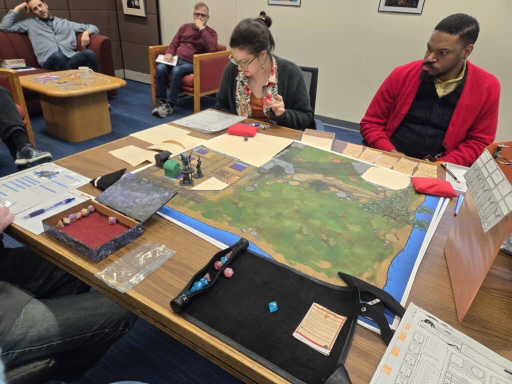 Members of the Collections Team playing and watching Dungeons & Dragons game session, image courtesy of Kristy Hisert.