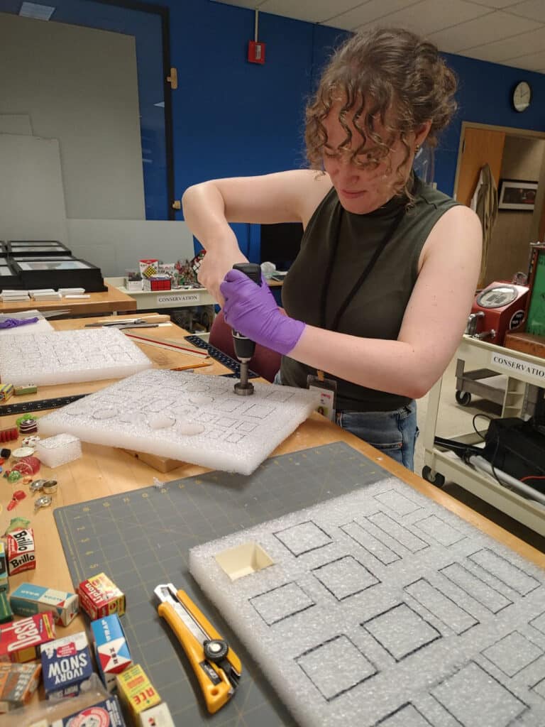 Dina Garber making custom archival housing during her internship. 